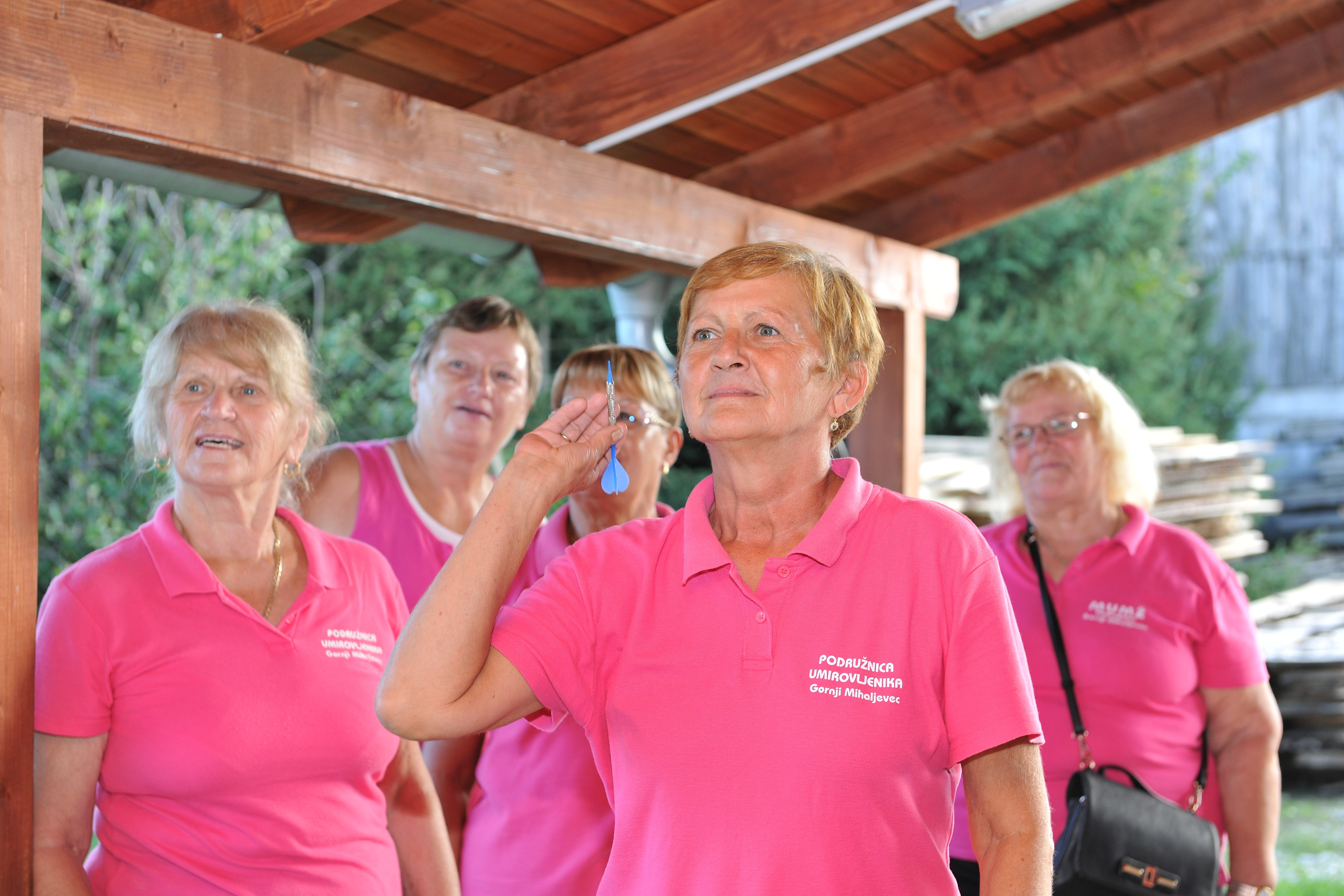 Senior's playing darts.